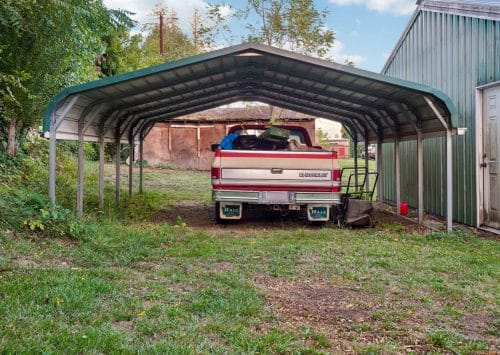 Carport providing vehicle protection at a LaPlace property